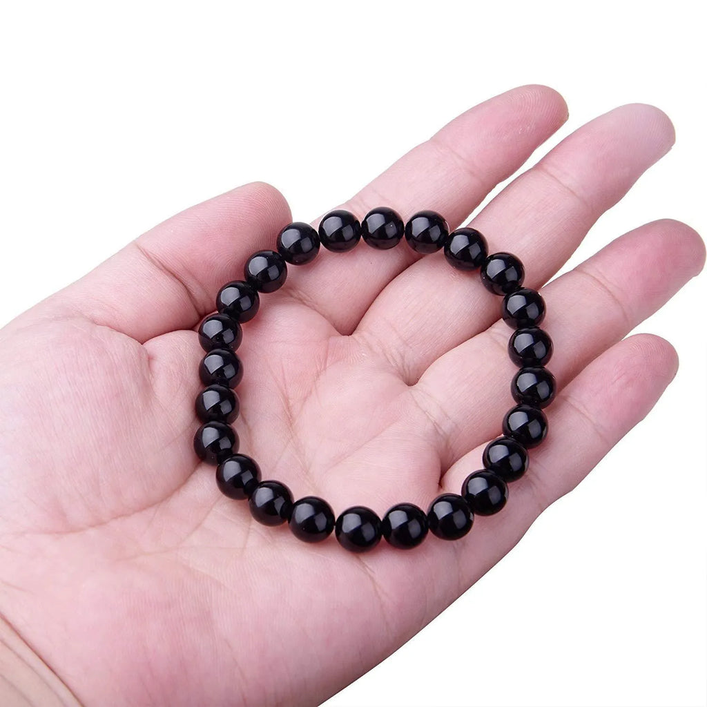 Black onyx bracelet with 8mm geometric beads on a stretchy elastic cord.