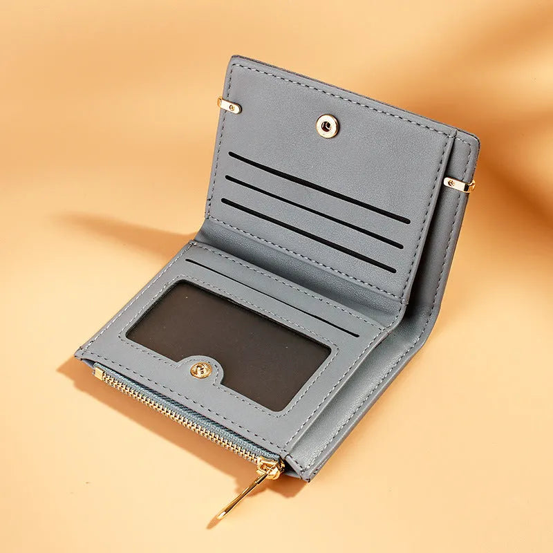 A folded ladies wallet in PU leather with a zipper, showing internal card slots and compartments.