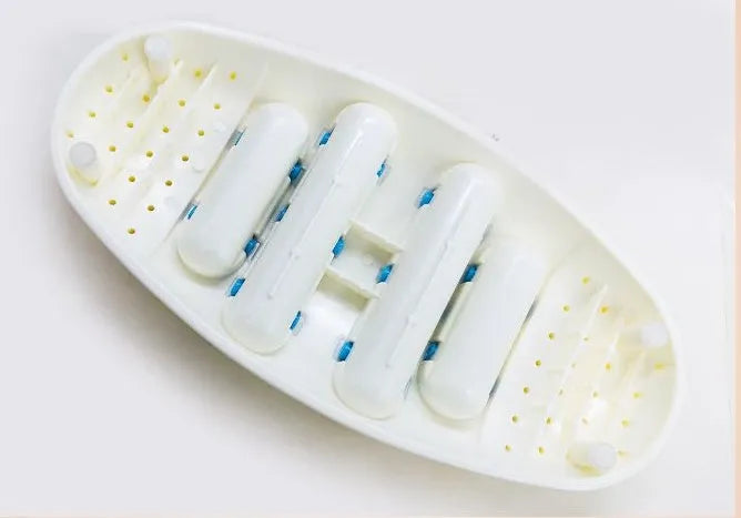 White plastic foot acupressure massager roller with ridged surface for plantar fasciitis and arch pain relief