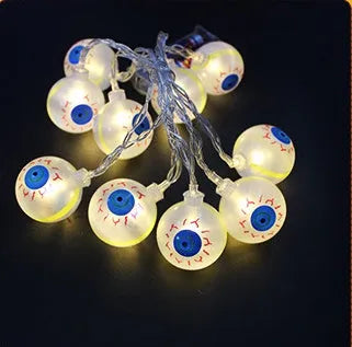 Halloween LED string lights with pumpkin, bat, and ghost decorations hanging on a wall