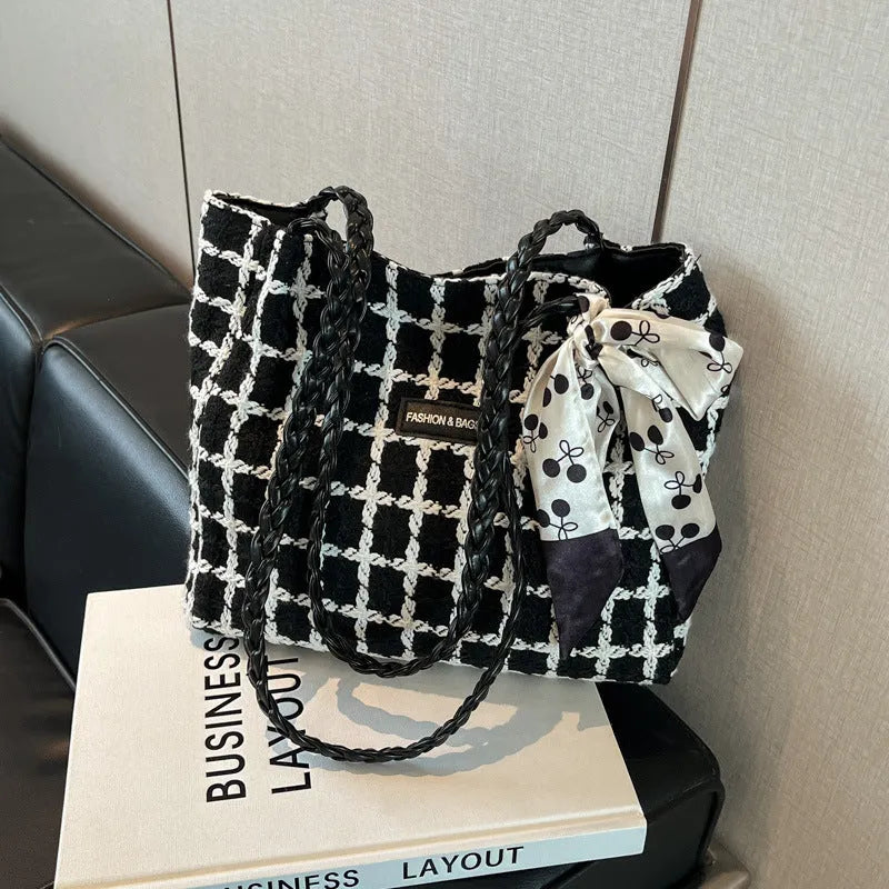 Black woven wool shoulder bag with horizontal square design and internal organisation compartments