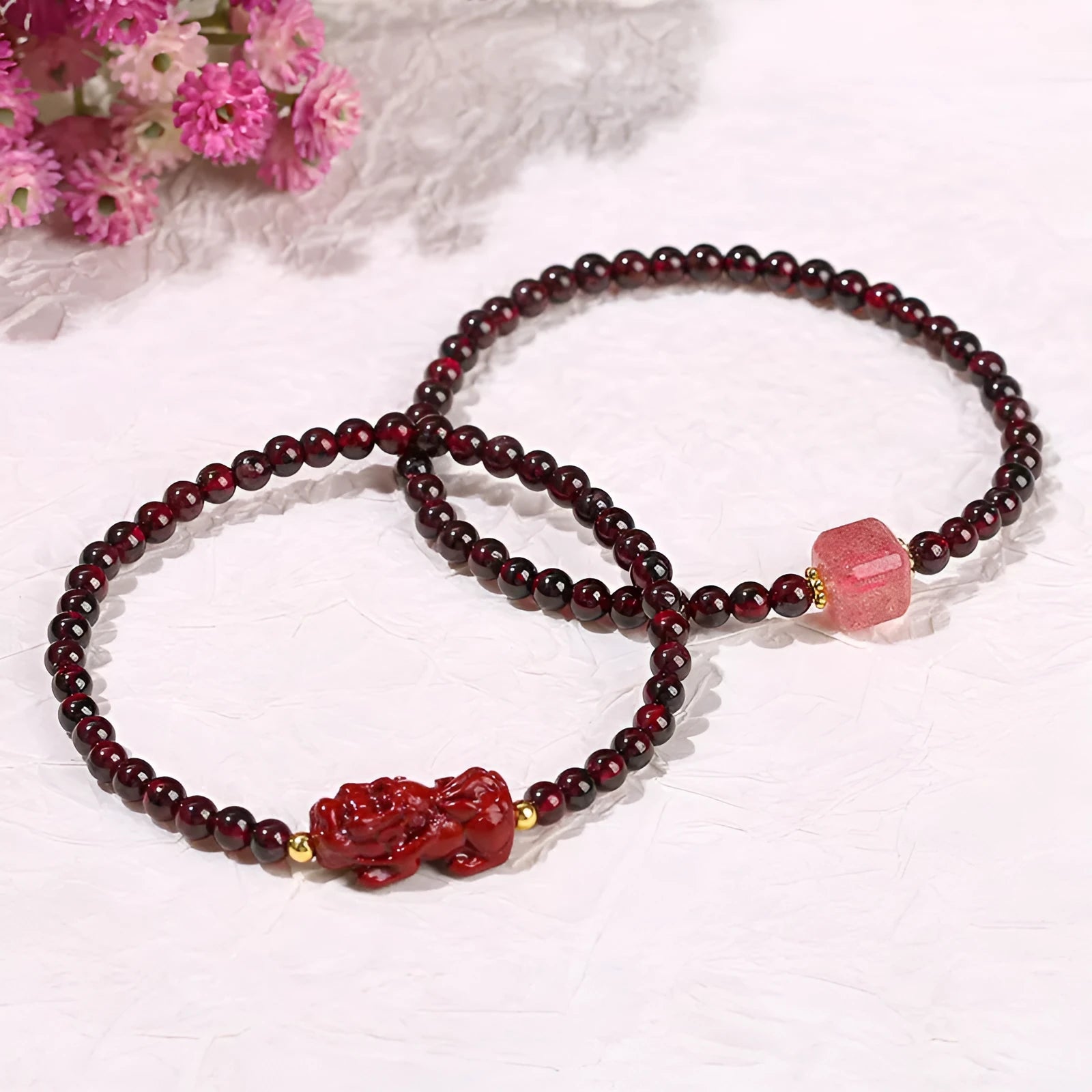 Geometric square garnet bracelet with carved purple pixiu charm on wrist