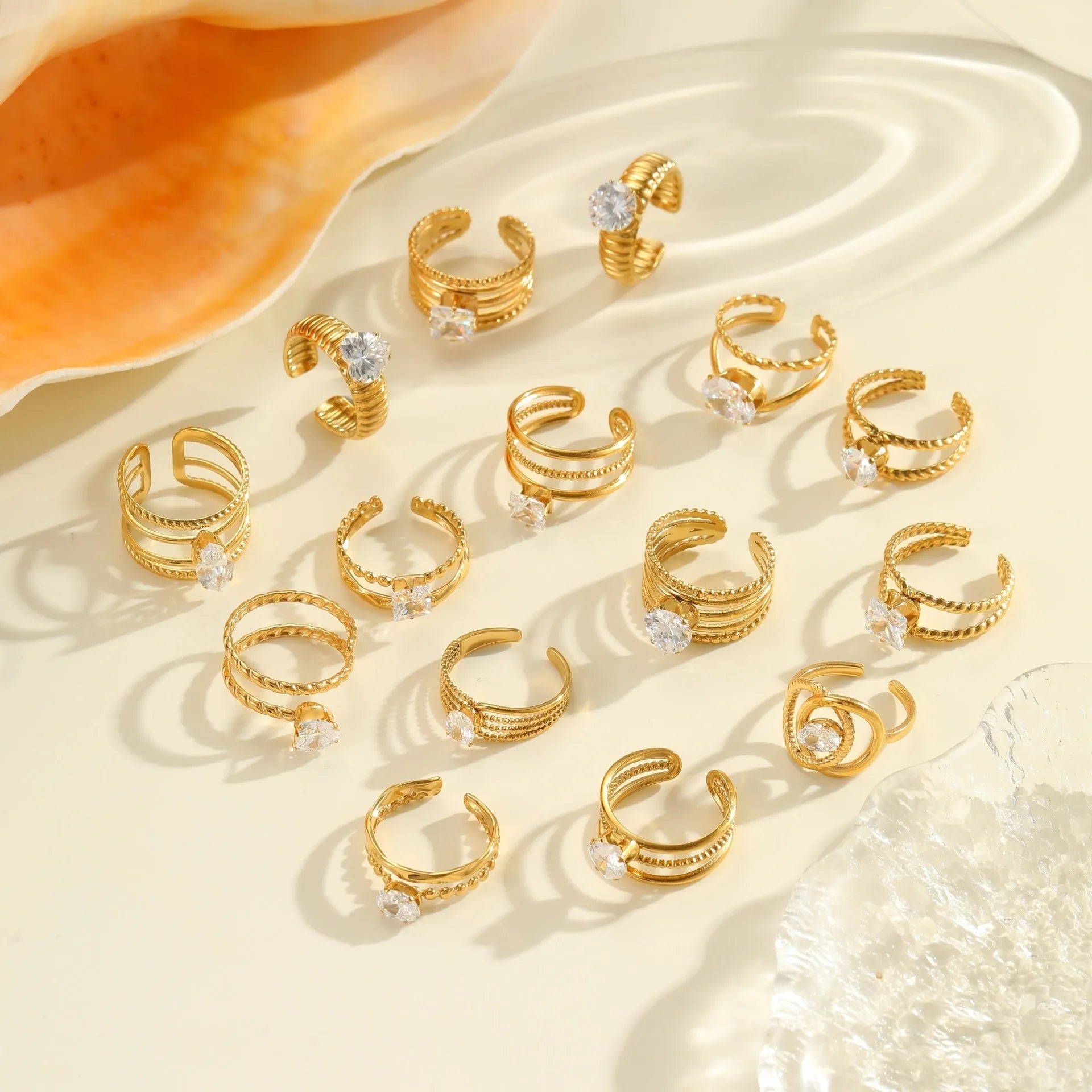 Gold electroplated stainless steel ring with zircon accents in open mouth geometry design