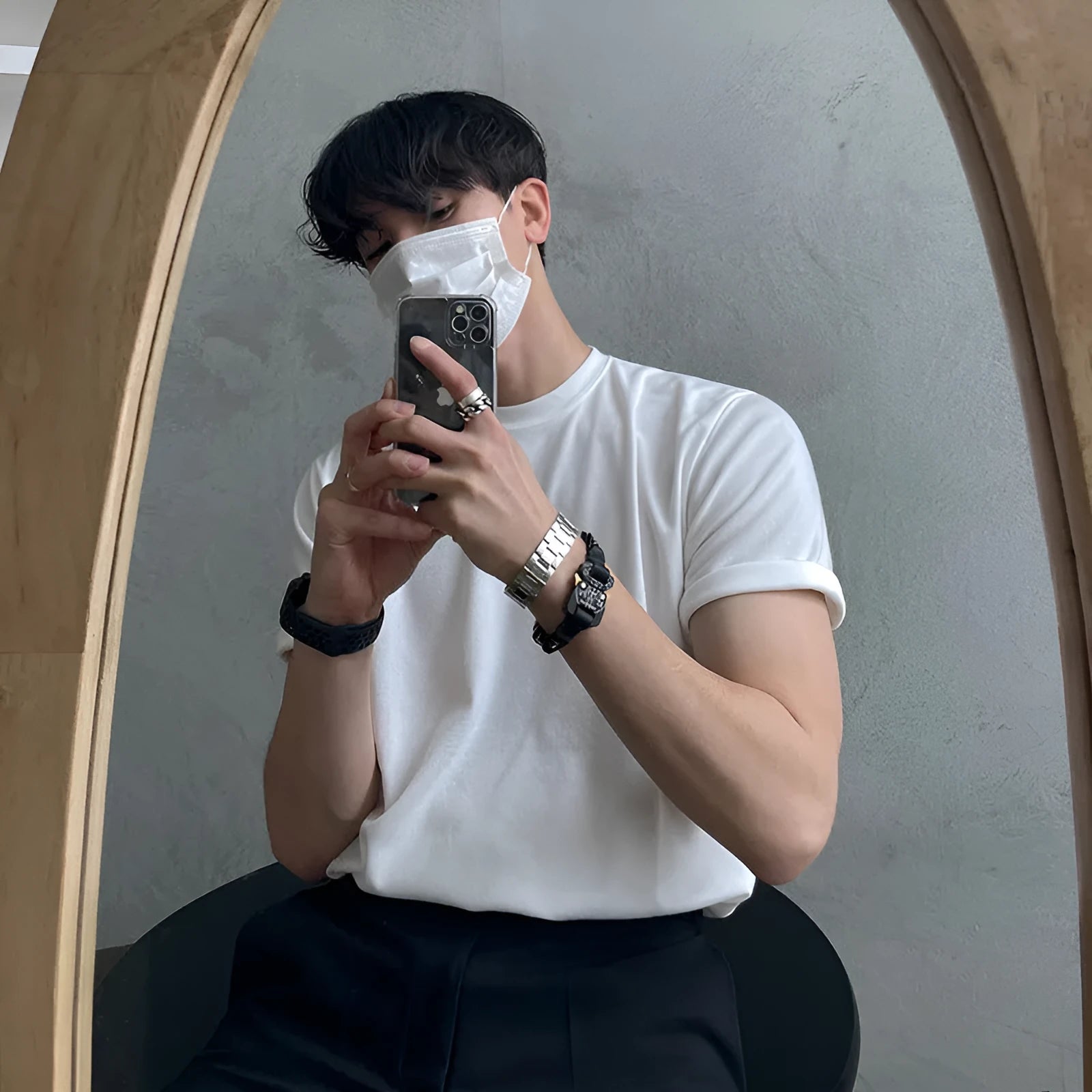 Men's slim fit cotton t-shirt in black with round neck and half sleeves on a model.