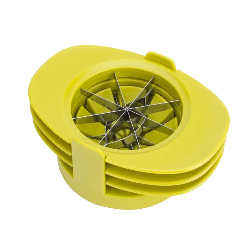 Green fruit slicer with three cutting sections for apple, tomato, and mango on a base