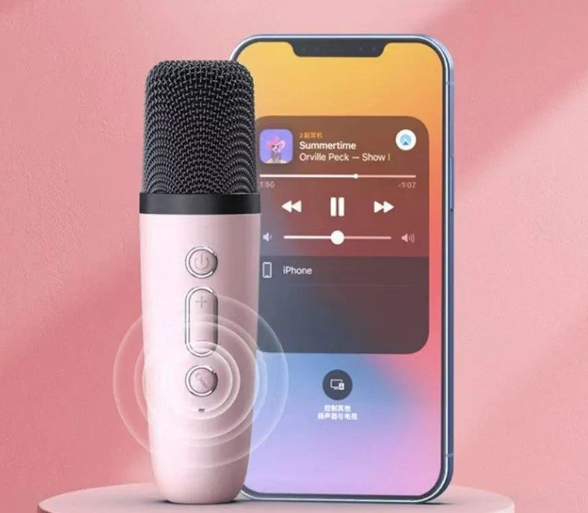 Pink Bluetooth speaker and microphone combo with coloured LED lights illuminated, placed on a table.
