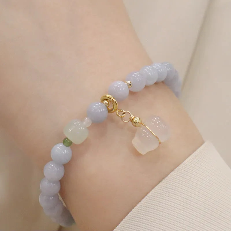Women's gold-plated bracelet with artificial crystal and chalcedony pendant in climbing cat design