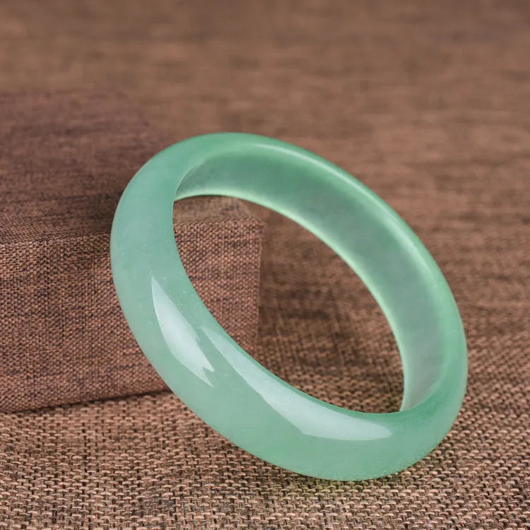 Oil cyan light green jade bracelet in modern simplicity style on wrist