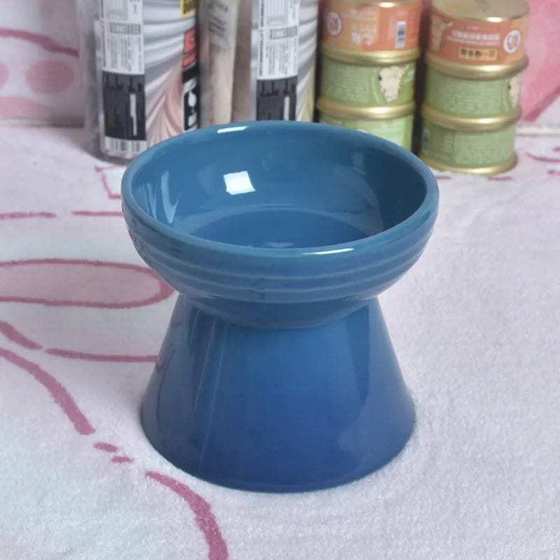 White ceramic pet bowl with a high foot base and wide, shallow eating area for dogs and cats