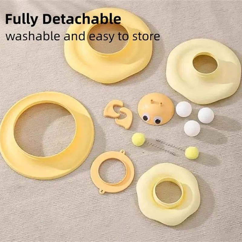 Cat toy tower with rotating bee toy and three-layer trackball in green plastic, placed on a wooden floor