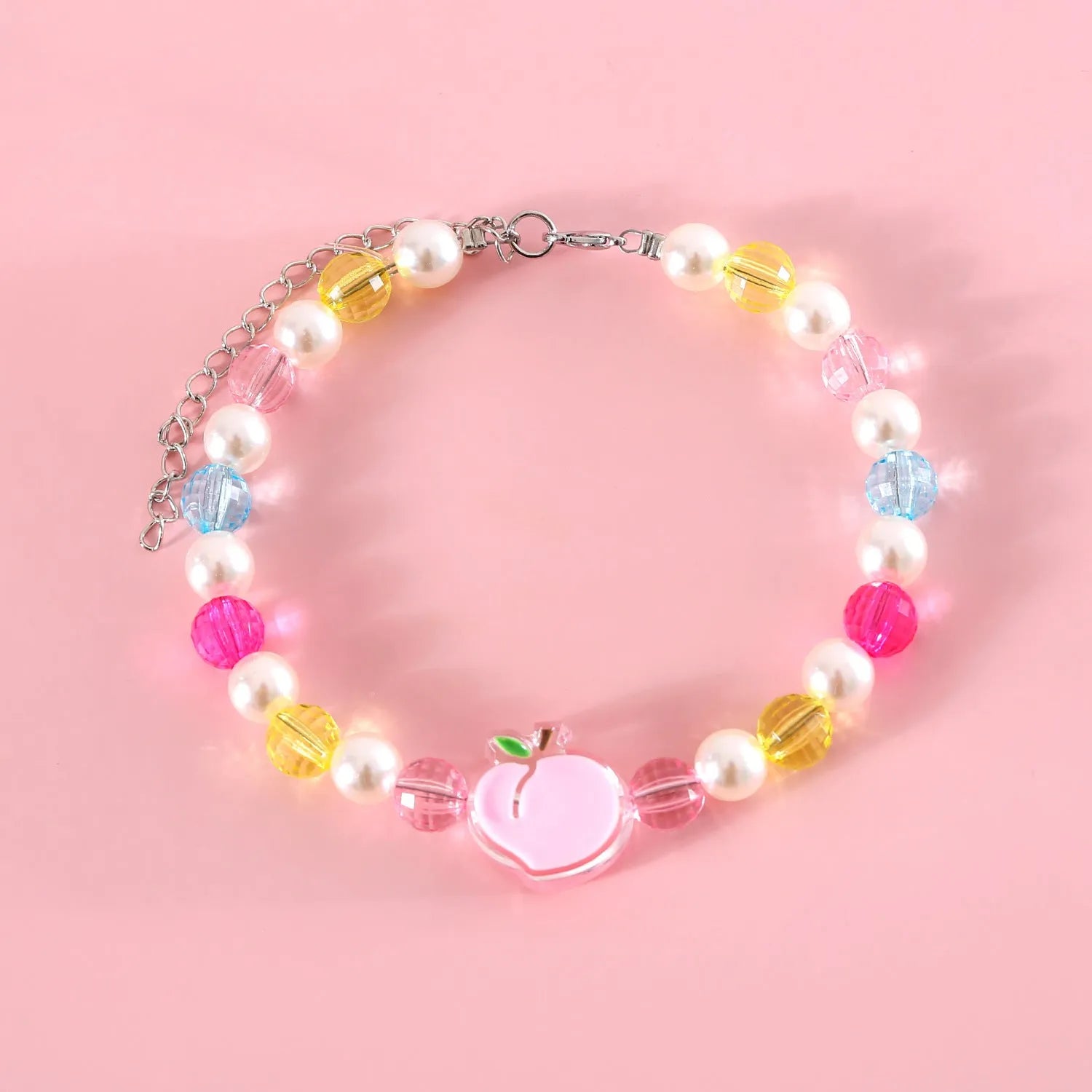 Colourful plastic bead pet necklace shown in peach, rainbow, and small flower patterns with an adjustable clasp.