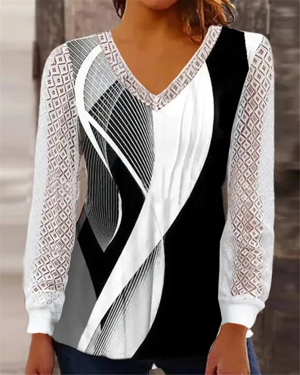 Women's loose purple V-neck lace top with long sleeves on a hanger.