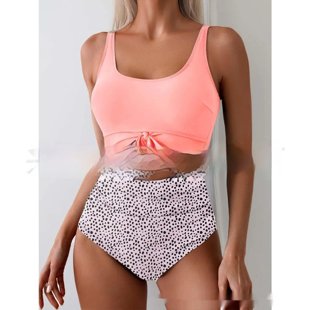 One-piece female swimsuit with contrast colour straps and covered belly in rose-red and black