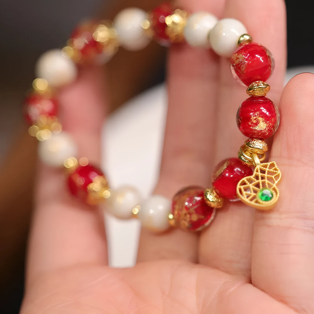 Handmade ethnic style coloured glaze bracelet with gold foil detailing and porcelain hanging gourd design
