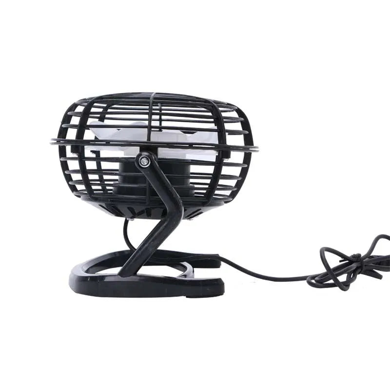Mini black USB desk fan with adjustable head on a desk next to a laptop.