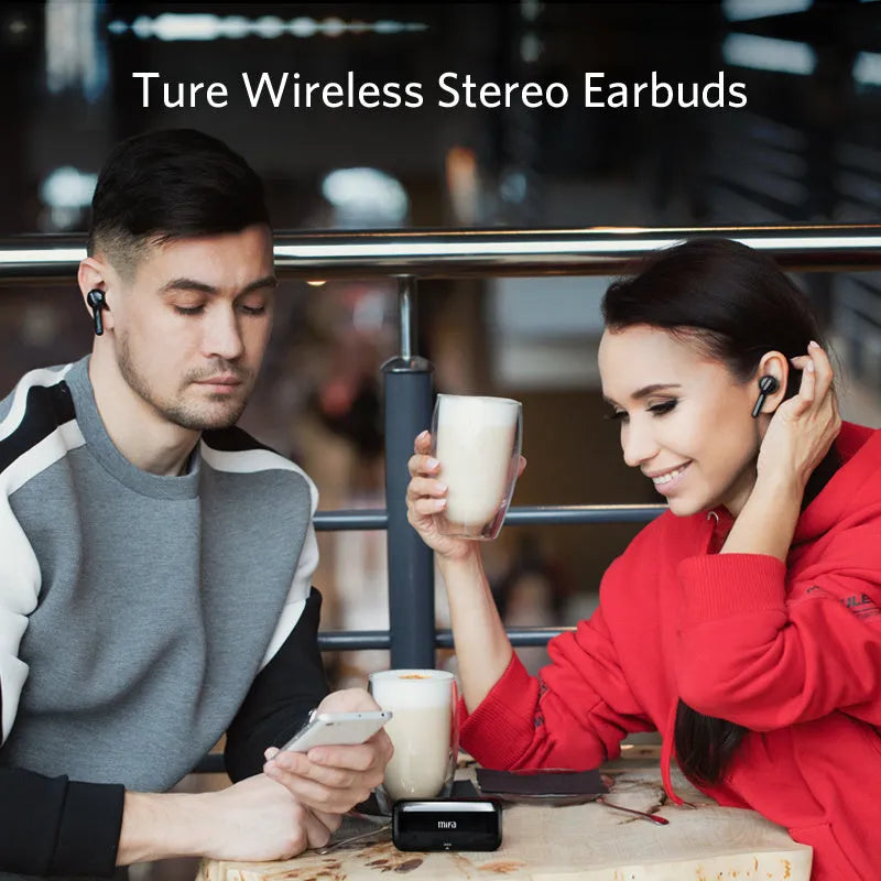 Black and white true wireless stereo earbuds with a compact charging case on a table.