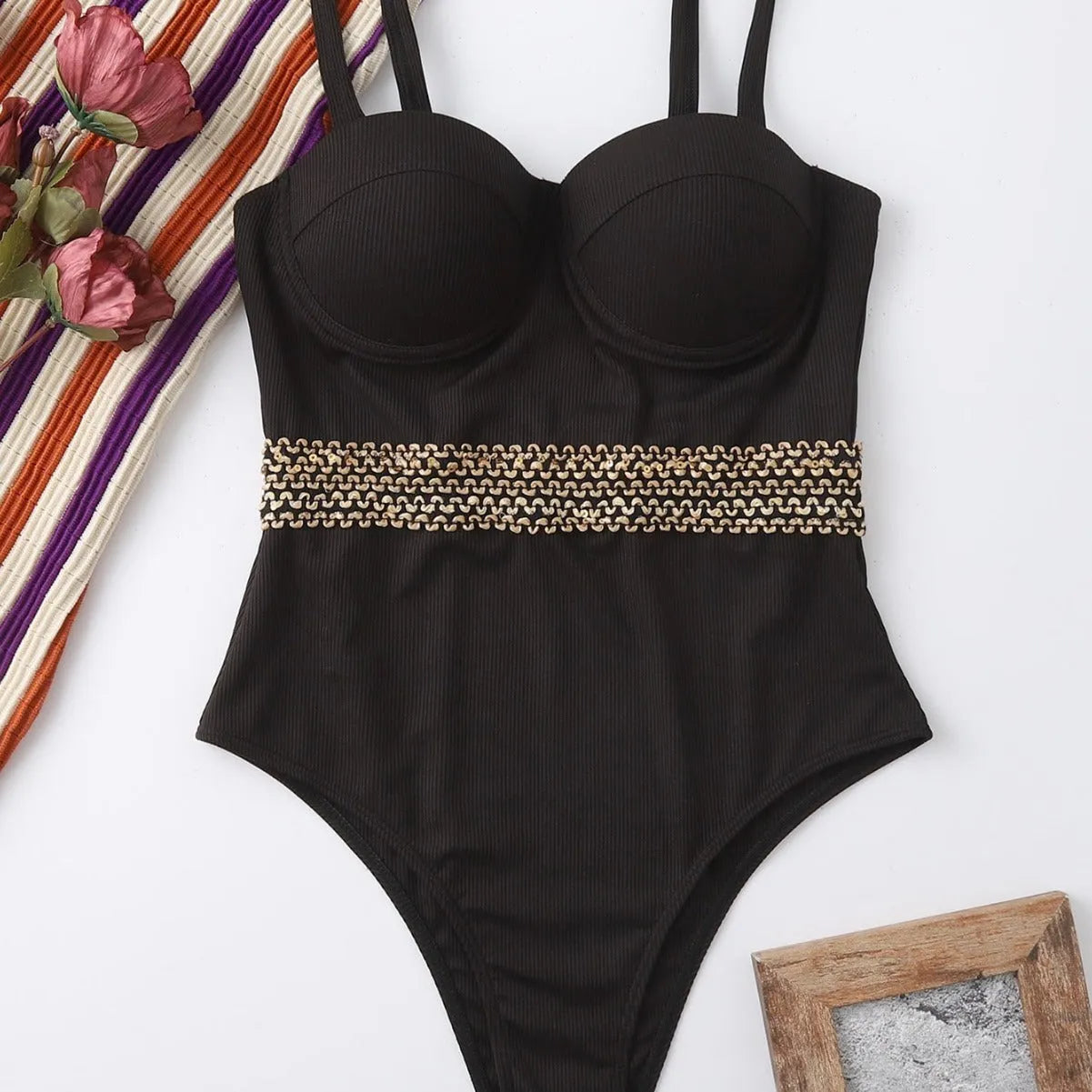 Black one-piece swimsuit for women with adjustable shoulder straps on a mannequin.