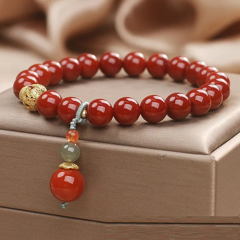 Red agate ethnic style bracelet for women on a plain background