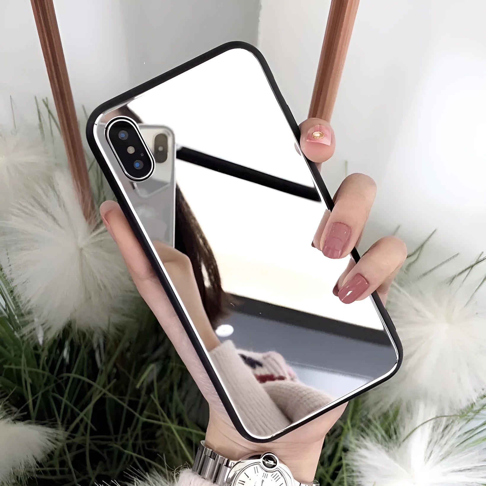 Black mirror back cover phone case for Apple iPhone X, 11, 12, 7, 8, and 6 models on a table.