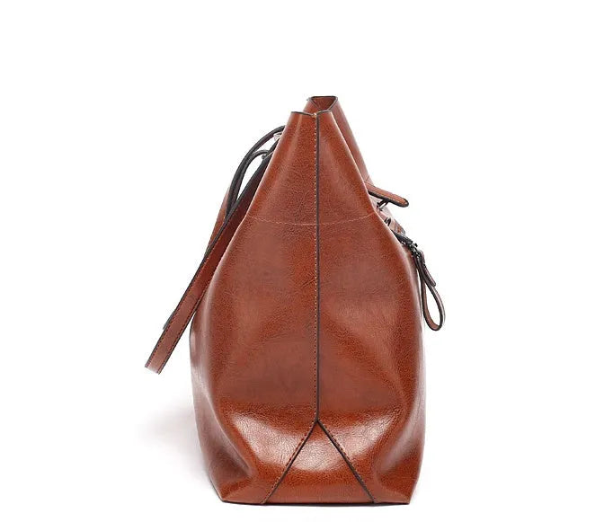 Brown waxed cowhide leather women's crossbody handbag with a structured shape and a front flap.