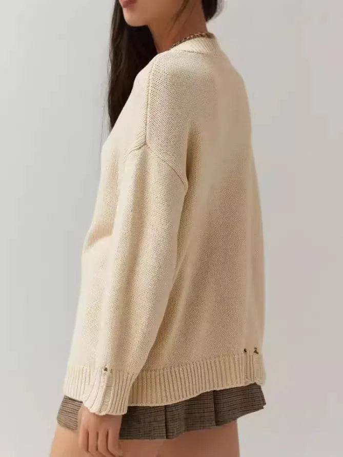 Women's loose-fitting acrylic sweater with round neck, long sleeves, and Jacquard craft in beige.