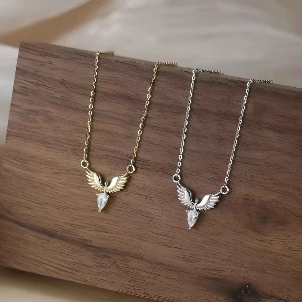 Close-up of an adjustable sterling silver necklace with an eagle pendant on an O-ring chain, showing white gold and yellow gold colour options.