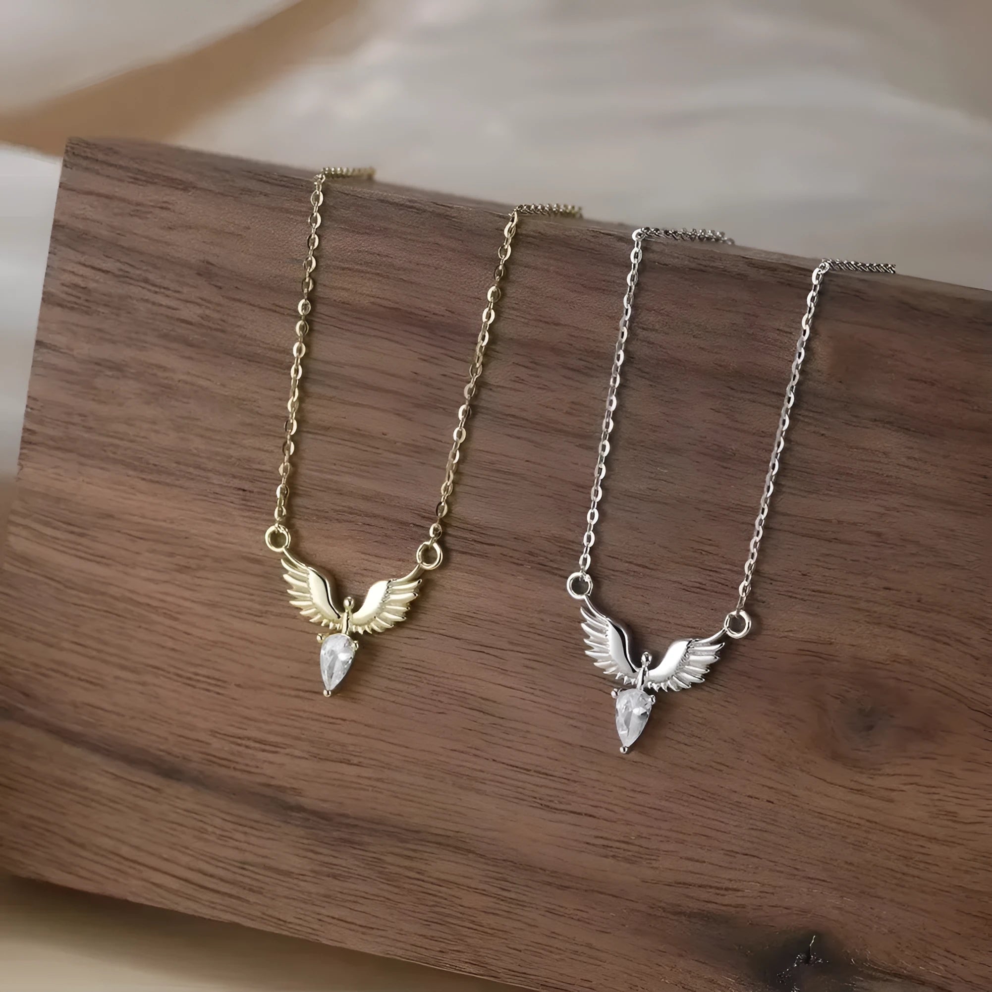 Close-up of an adjustable sterling silver necklace with an eagle pendant on an O-ring chain, showing white gold and yellow gold colour options.