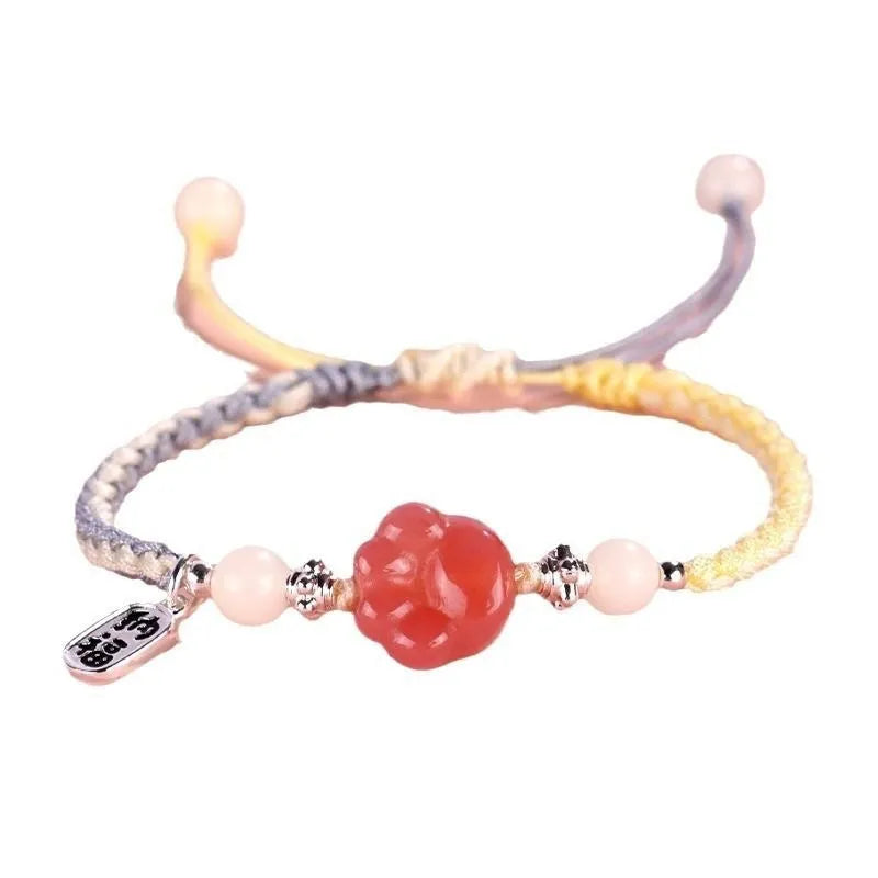 Red cat's paw charm couples bracelet with pink woven base, handmade glass and glaze jewellery