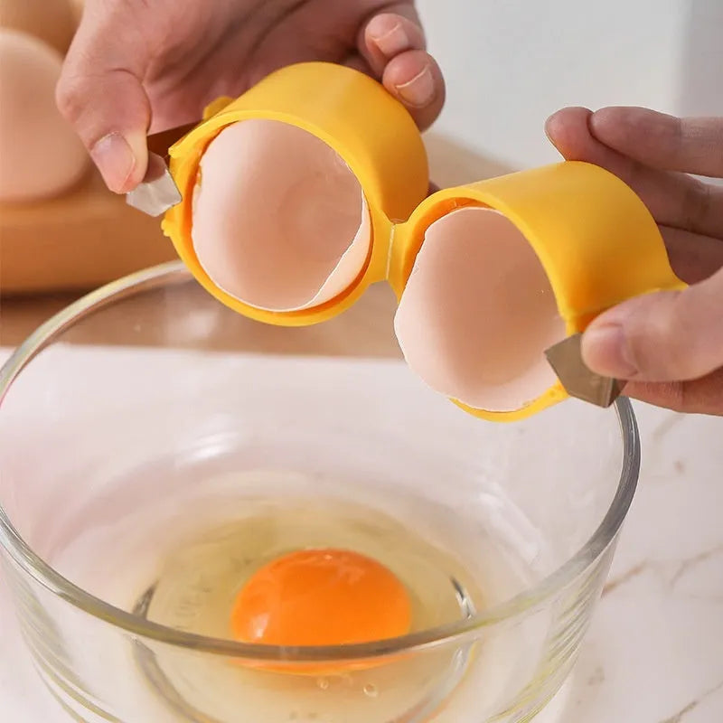 Colourful egg shell opener and beater kitchen tool made of stainless steel and plastic on a kitchen counter.