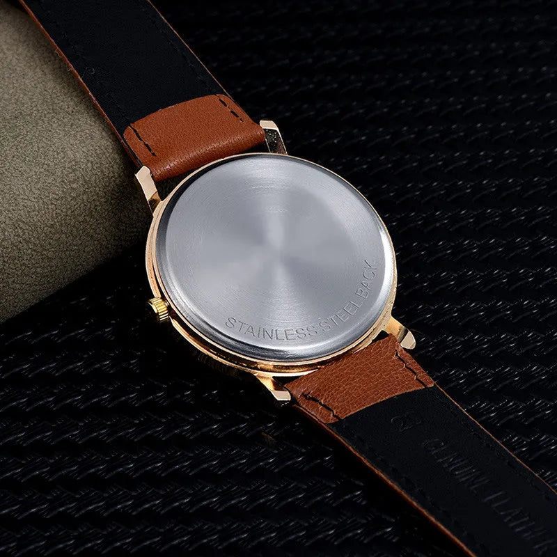 Love Tree round dial leather strap casual wrist watch in black on a tabletop