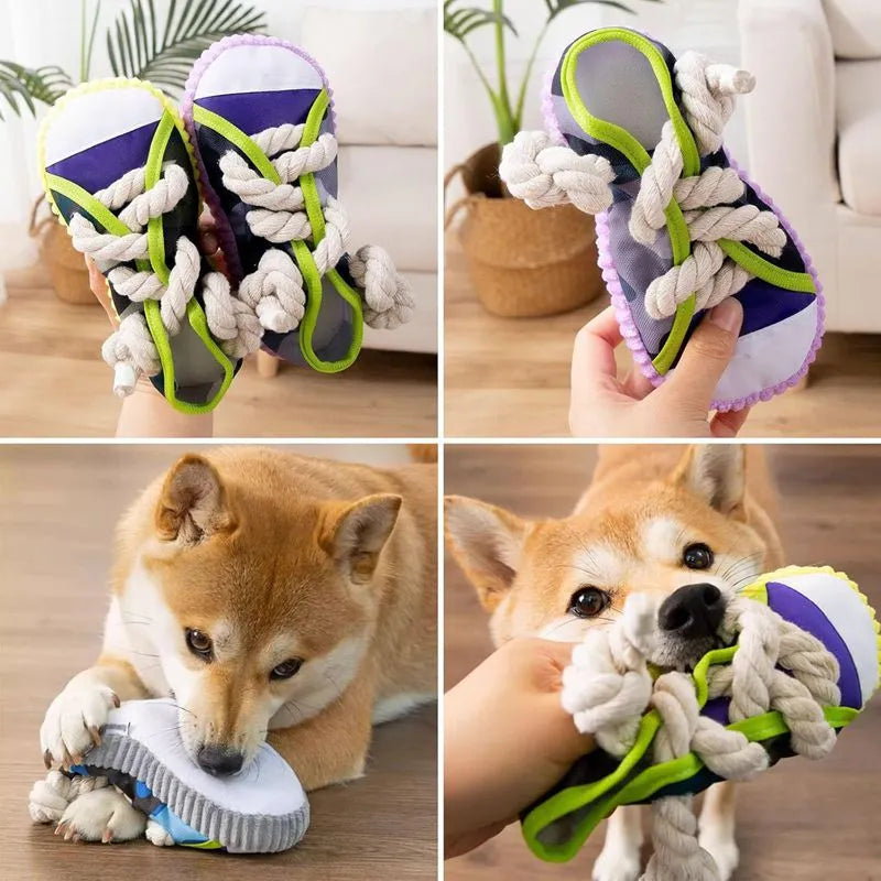 Grey and white dog toy slipper with black laces, blue sole, and a bell on the side