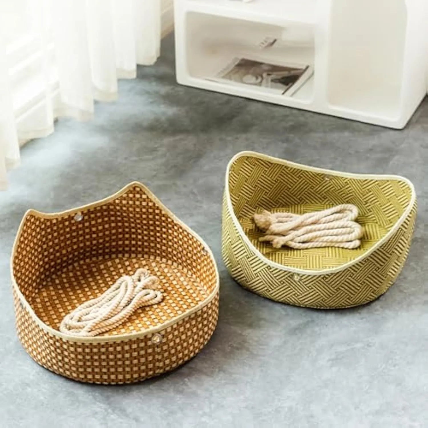 Green rattan cat hammock with cotton ropes and metal hooks, shown hanging.