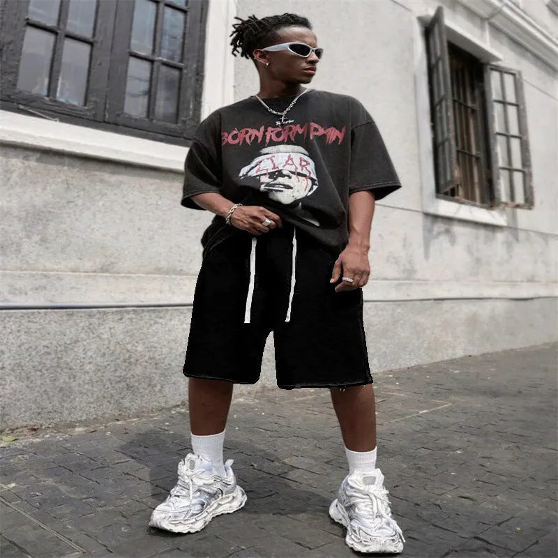 Men's black straight-leg hip-hop trousers in a medium length, laid flat.