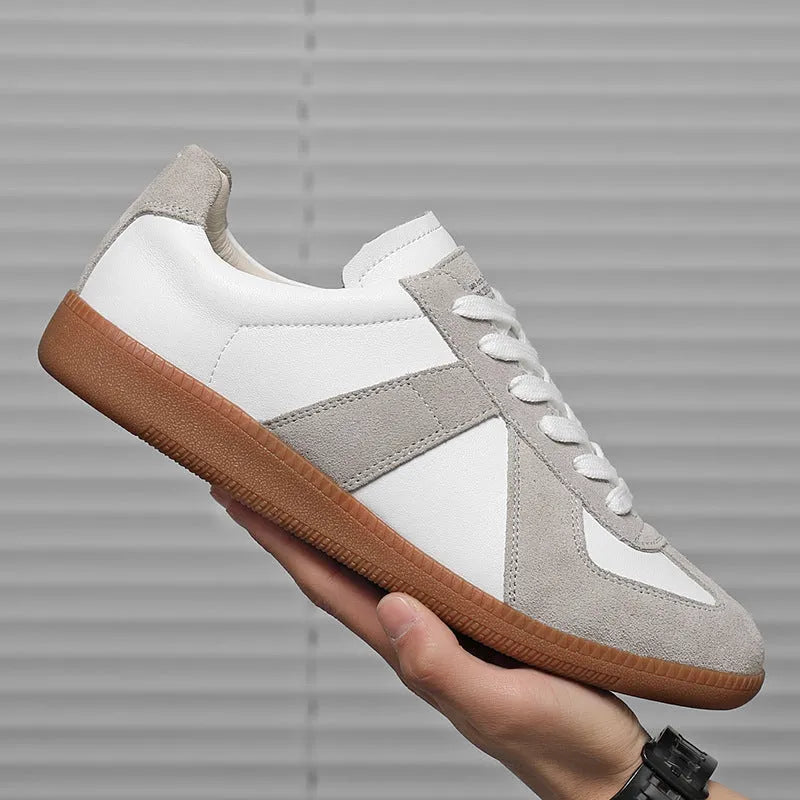 White Japanese-style retro low-top sneakers with mesh lining and a flat rubber sole on a plain background.