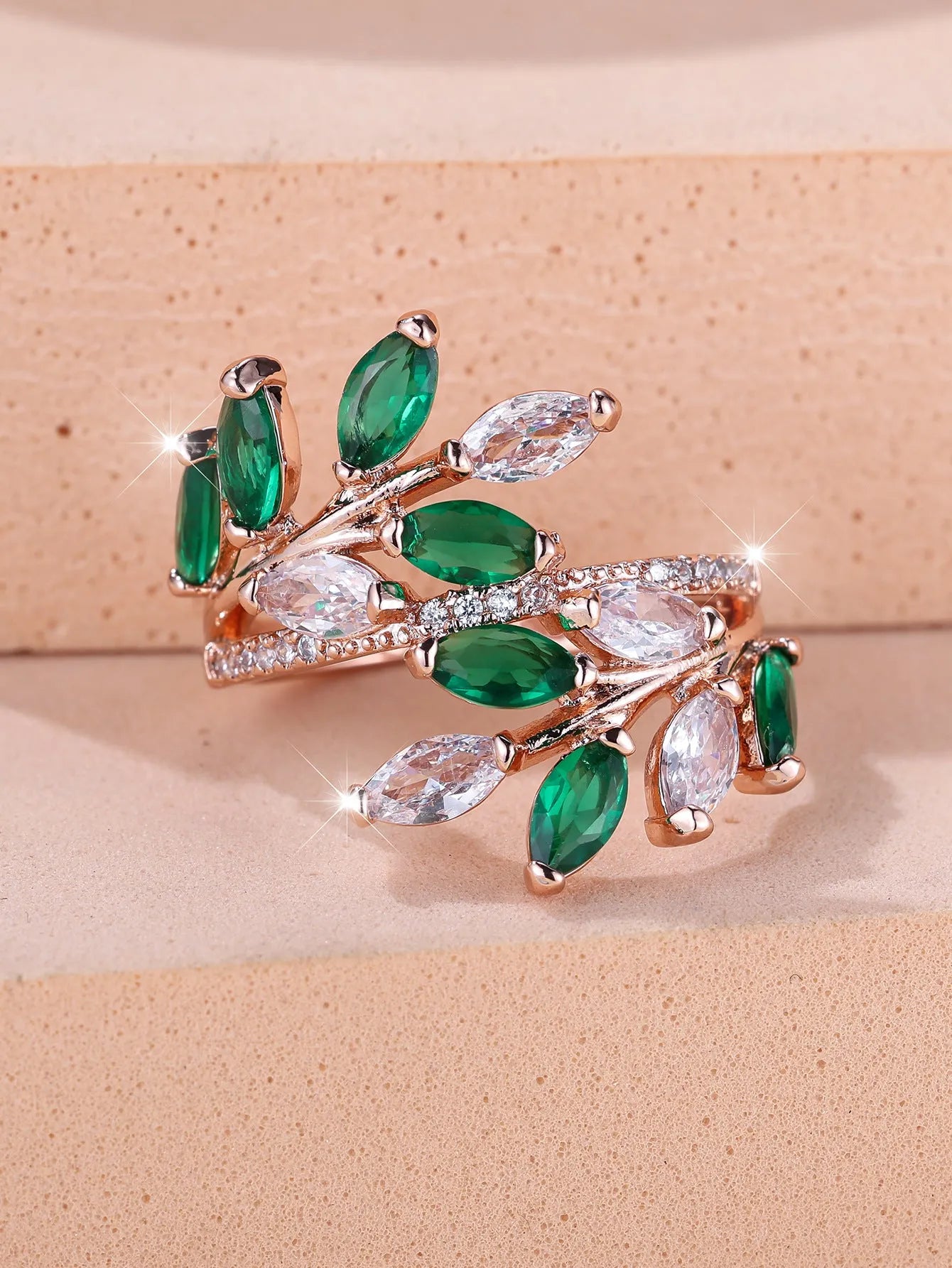 Adjustable copper leaf-shaped ring with a central horse eye zircon stone, shown in a rose gold finish.