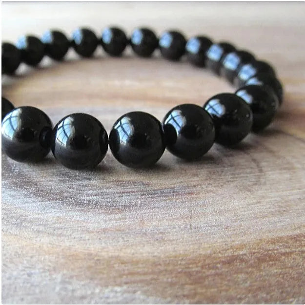 Black onyx bracelet with 8mm geometric beads on a stretchy elastic cord.