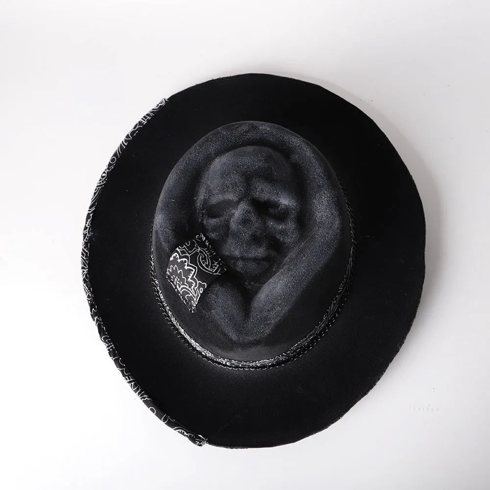 Handmade black wool felt skull hat with conical crown and blue denim accent band, shown from the side.