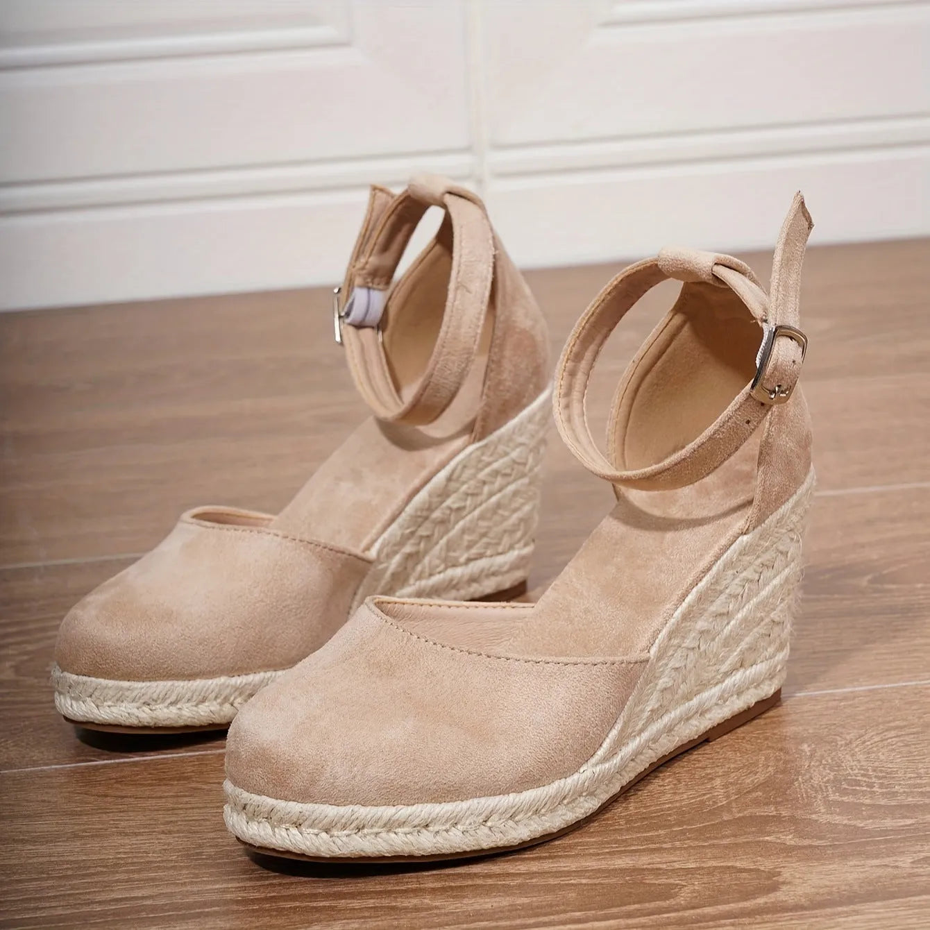 Women's apricot suede wedge sandals with an adjustable ankle buckle and rubber sole.