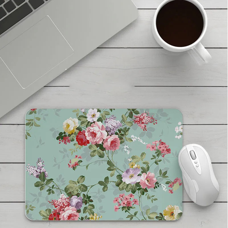 Thick custom cartoon mouse pad with colourful design on a desk, showing black seam edge