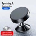 Black magnetic car phone holder mounted on a car dashboard, holding a smartphone