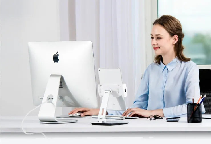 Silver foldable aluminium phone tablet holder on desk showing 360° rotation