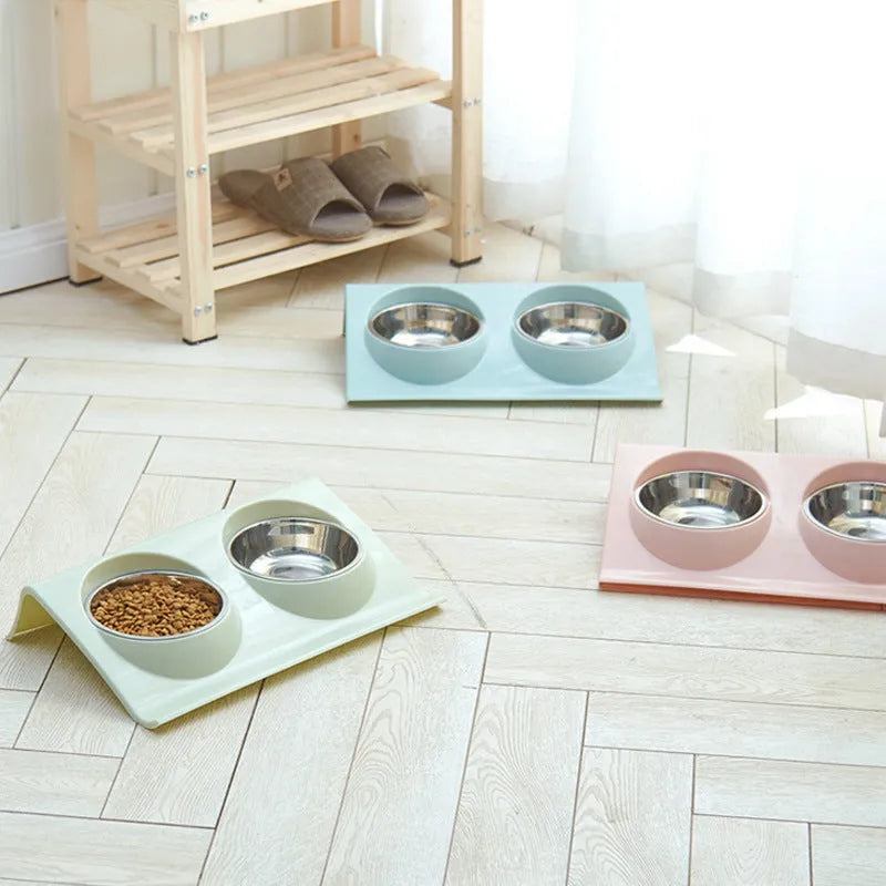 Stainless steel pet double bowl with green PP base and metal inner bowl on floor