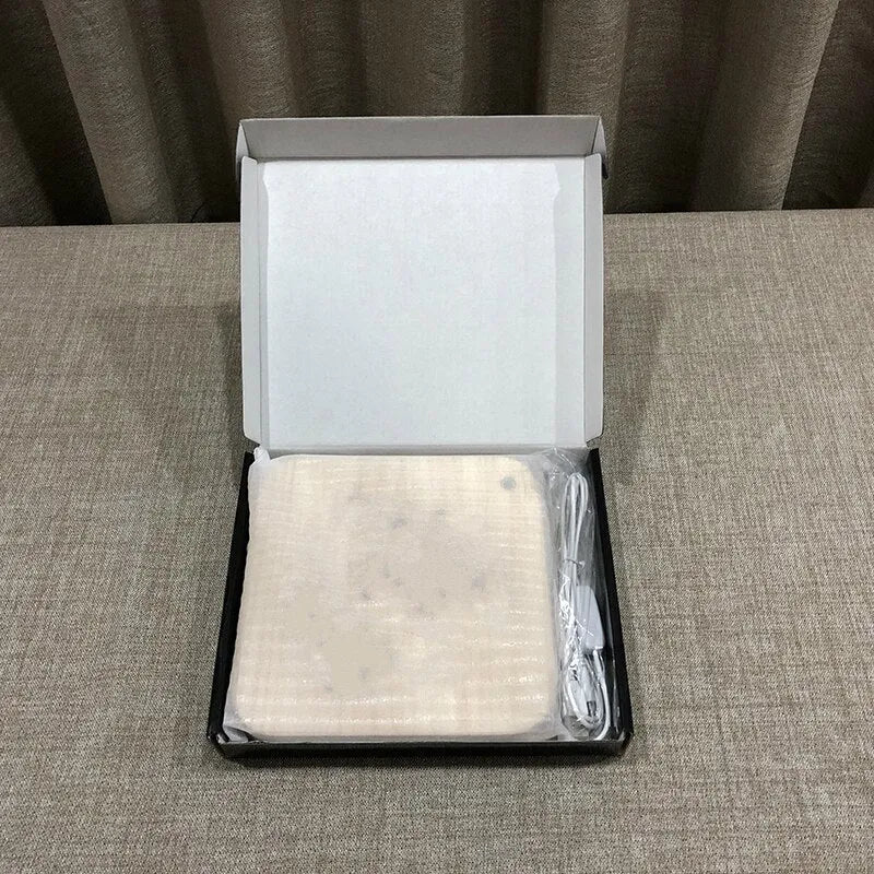 Square pine wood USB LED lamp emitting warm white light on a wooden surface.