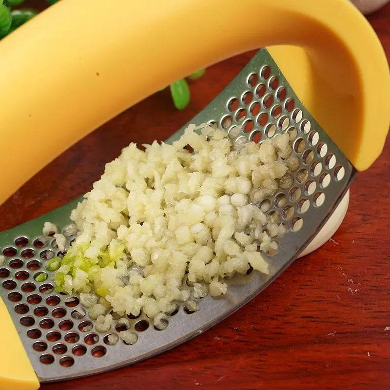 Stainless steel manual garlic press with ergonomic handle in assorted colours