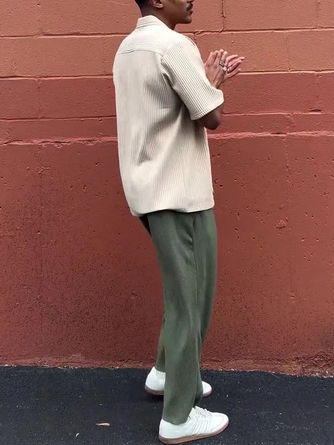 Men's green pleated casual trousers in polyester fabric showing ankle-length design and regular fit