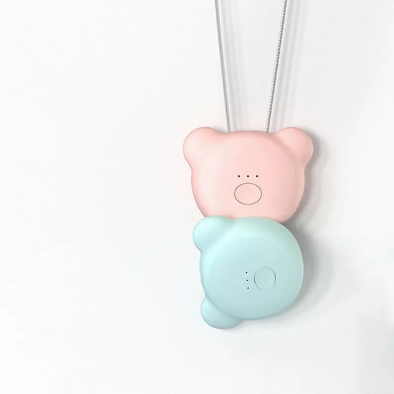 Mini USB portable air purifier necklace in pink, showing compact size and wearable design.