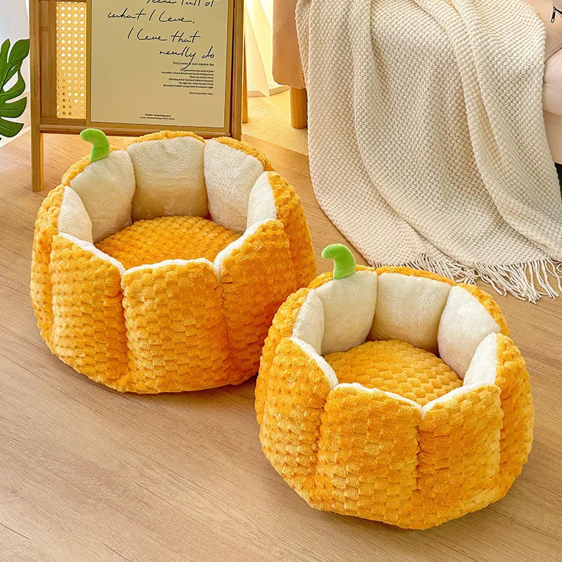 Orange pumpkin-shaped pet bed nest for cats and small dogs on a wooden floor.