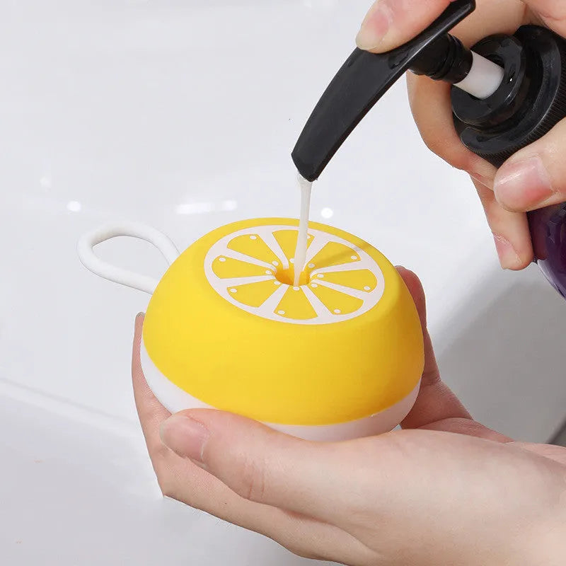 A soft silicone pet bath brush with a massage head design, shown in yellow, for grooming dogs and cats.