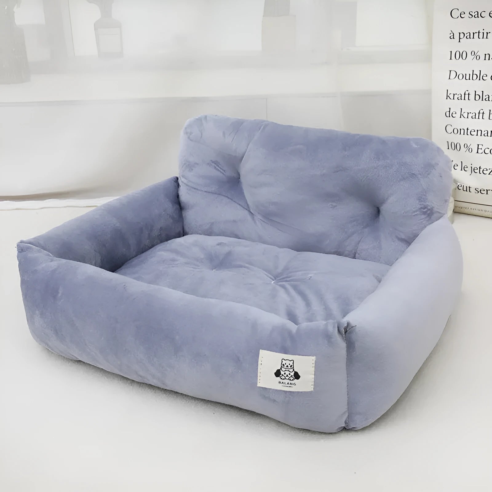 Grey and blue plaid washable fabric dog travel nest for car use, shown in two sizes.
