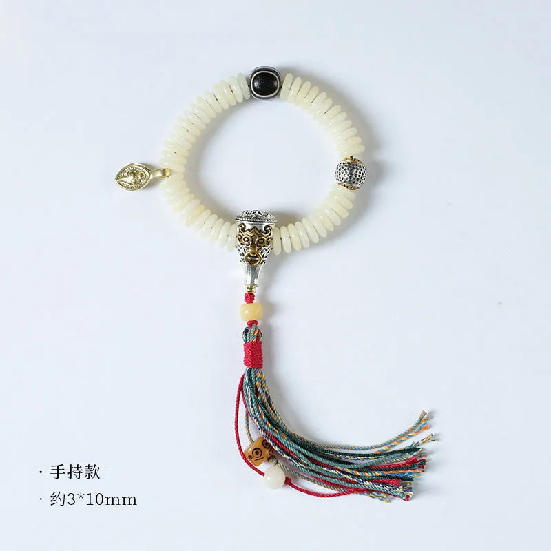 Close-up of a White Bodhi seed bracelet showing its 3x10mm beads and string.